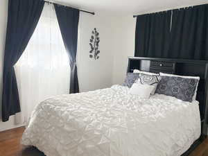 Bedroom featuring dark wood-style flooring
