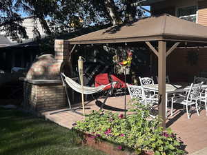 View of patio featuring outdoor dining space and a fireplace