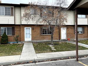 Colonial house with brick siding and a front lawn