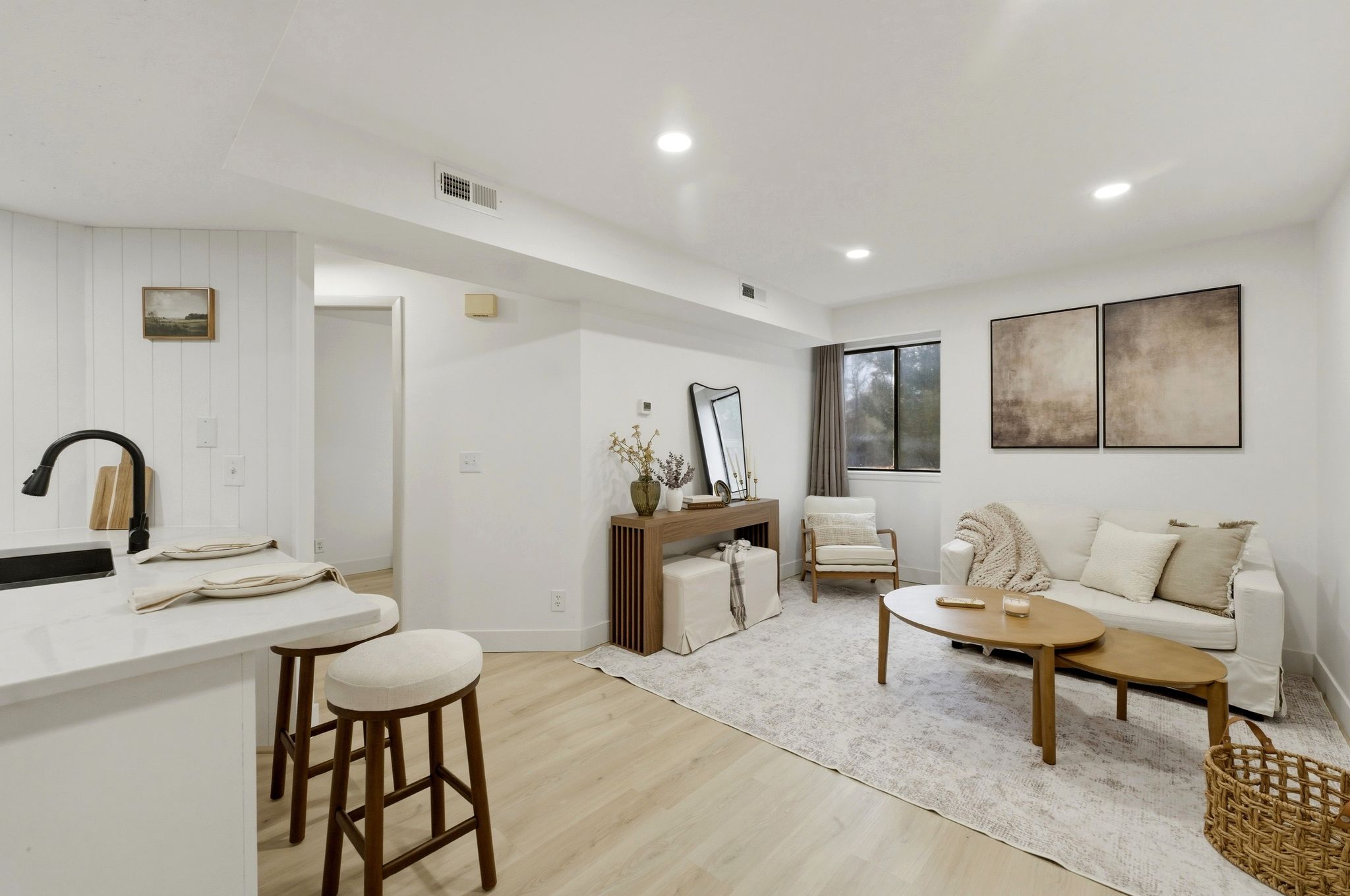 Living room with light wood-style vinyl LVP flooring and recessed lighting