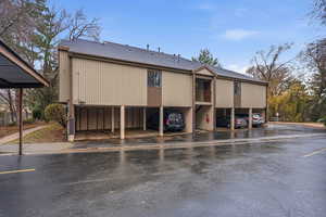 View of building exterior with covered parking