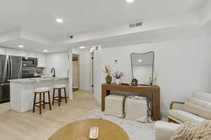 Living room featuring recessed lighting and light wood-type flooring
