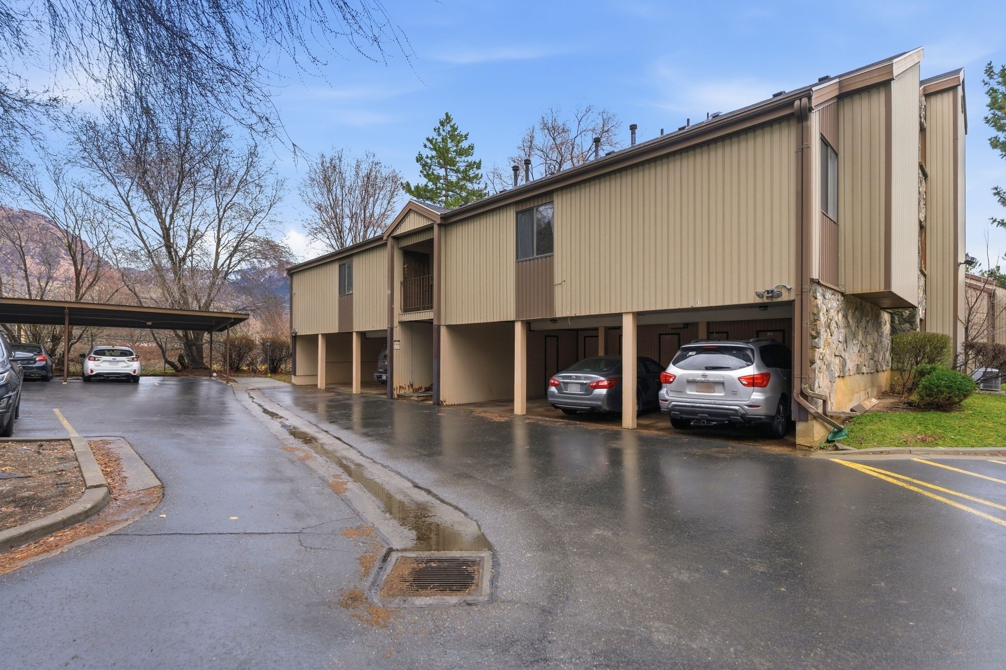 View of building exterior with covered parking