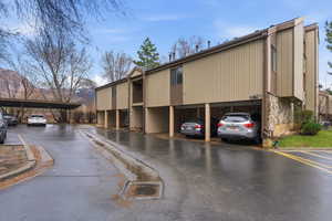 View of building exterior with covered parking