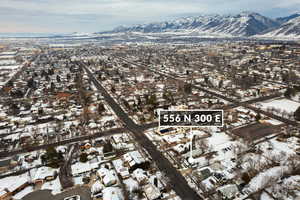 Snowy aerial view with a residential view and a mountain view