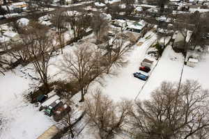 Snowy aerial view featuring a residential view
