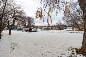 Yard covered in snow featuring a residential view