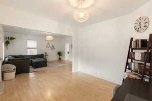 Living room with light wood-type flooring and baseboards