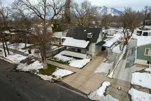 Snowy aerial view featuring a mountain view and a residential view