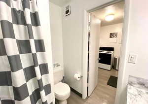 Full bathroom featuring curtained shower, light wood-type flooring, and vanity