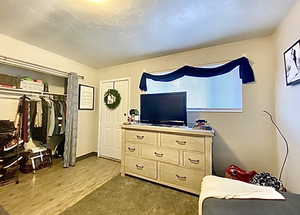 Bedroom with a closet and light wood-style floors