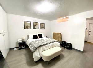 Bedroom featuring wood finished floors and a textured ceiling