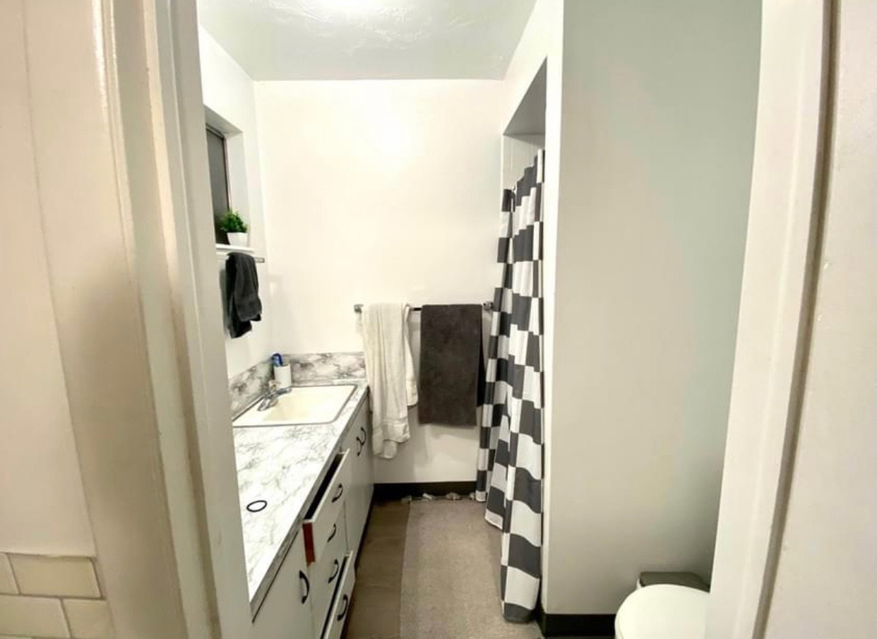 Bathroom with vanity and curtained shower