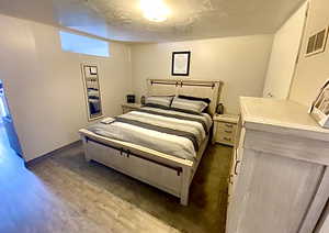 Bedroom with dark wood-type flooring