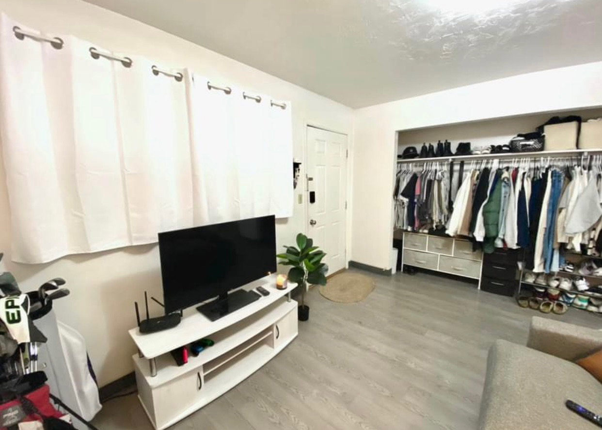 Living area with wood finished floors and baseboards