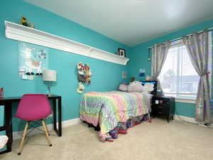 Bedroom featuring light colored carpet