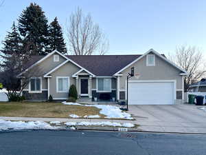 View of front of home with stone siding, stucco siding, a garage, concrete driveway, and roof with shingles