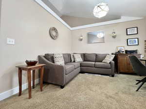 Living area featuring light colored carpet and vaulted ceiling