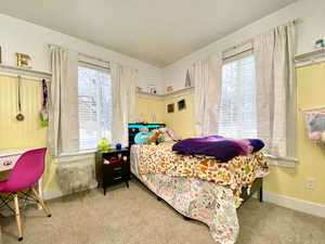 Bedroom with light carpet and baseboards