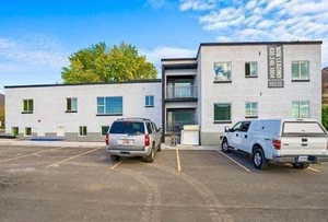 View of property featuring uncovered parking