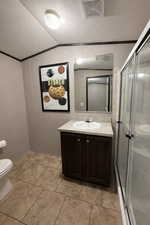 Bathroom featuring vanity, a shower stall, crown molding, and light tile patterned floors