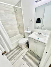Full bathroom with vanity and shower / bath combination with curtain