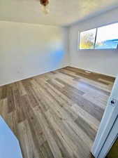 Spare room featuring dark wood-type flooring