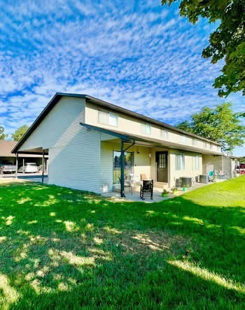 Rear view of house with a patio and a yard