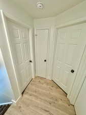 Hall with light wood finished floors