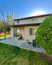 Back of property featuring a yard and a patio area