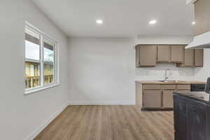 Dining area with light wood-style floors and recessed lighting