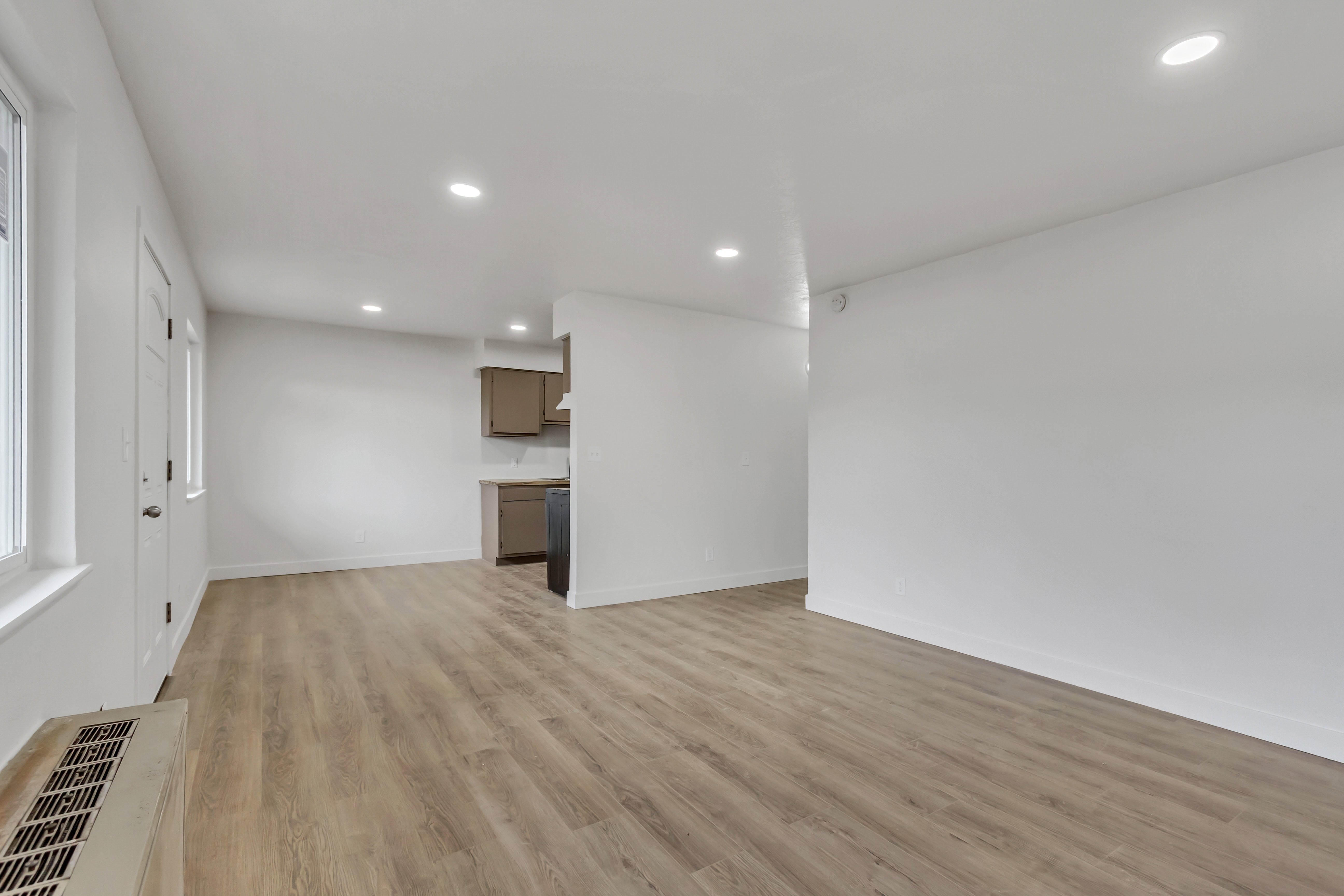 Family room with light wood-style floors and recessed lighting