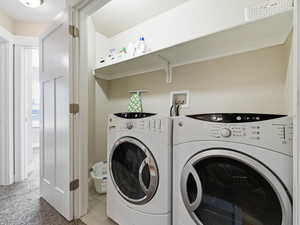 Laundry area with space for separate washer and dryer, and supplies storage shelf