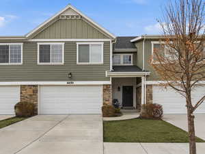 Craftsman-style home featuring board and batten siding, stone siding, 2-car garage
