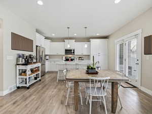 Dining space featuring light wood-style floors and recessed lighting