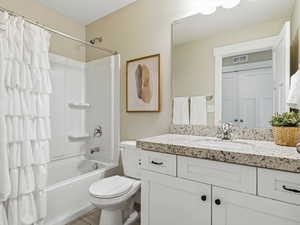 Full bath featuring granite countertop vanity and shower / tub combo