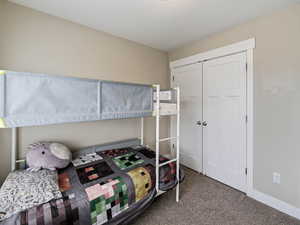 Bedroom with blinds, carpet and french door wide closet