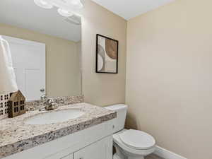 Half bathroom with granite vanity countertop