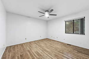 Spare room with ceiling fan and light wood finished floors