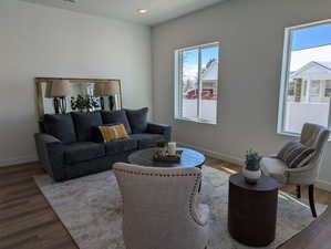 Living area with wood finished floors and recessed lighting