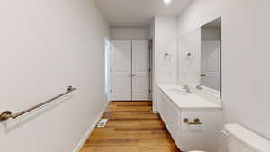 Half bath with vanity and light wood-style flooring