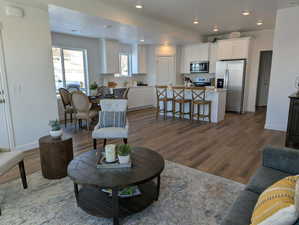 Living area with dark wood-type flooring, recessed lighting, and a textured ceiling