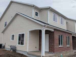 View of front of house with brick siding and covered porch