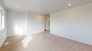 Unfurnished room featuring light carpet and recessed lighting
