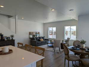 Dining room featuring a textured ceiling, dark wood-style floors, and recessed lighting