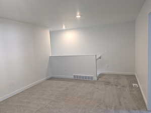 Unfurnished room with carpet and baseboards