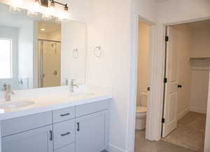 Primary bath with dual vanity, painted wood cabinets, quartz slab countertops, separate tub and shower.