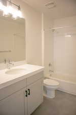 Full secondary bath with painted wood cabinets and quartz slab countertops.