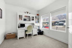 Office with light carpet and baseboards