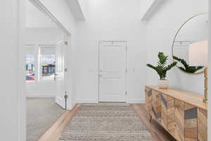 Entrance foyer with light wood finished floors and baseboards